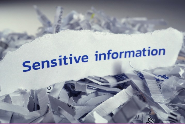a piece of paper with the word sensitive information on it