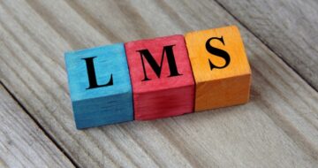 the word LMS, learning management system, spelled out on wooden blocks