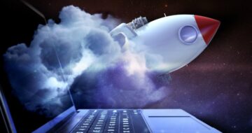 a laptop with a rocket ship flying out that represents speed