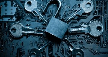 a padlock and keys on a circuit board representing a security breach
