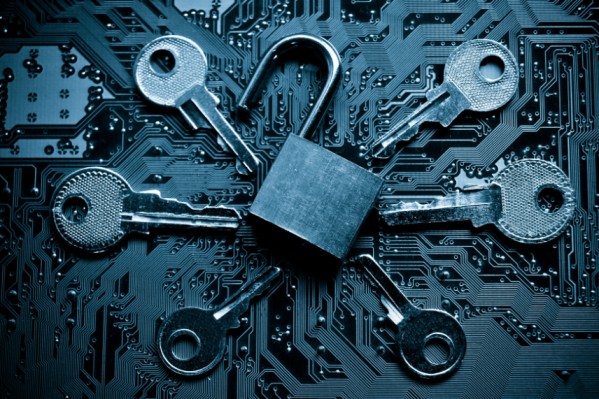 a padlock and keys on a circuit board representing a security breach