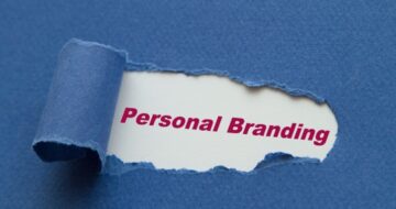 a torn piece of paper with the word personal branding appearing through it