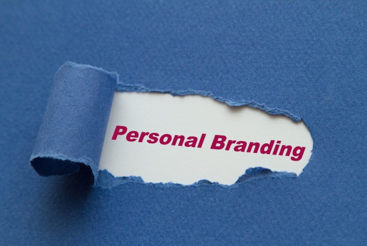 a torn piece of paper with the word personal branding appearing through it